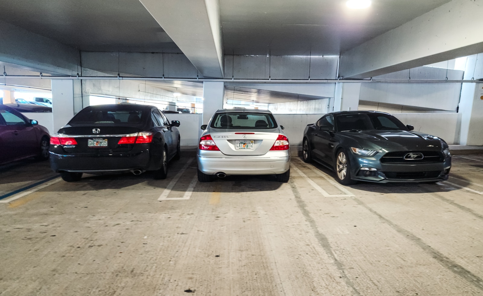 A group of cars parked in a parking garage